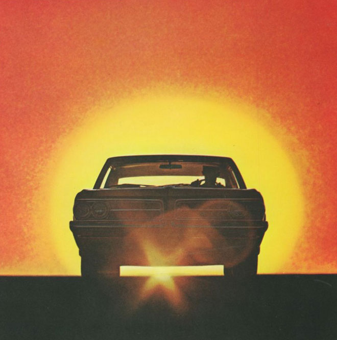 Head-on front view of a 1964 Pontiac GTO with a sunset for a background