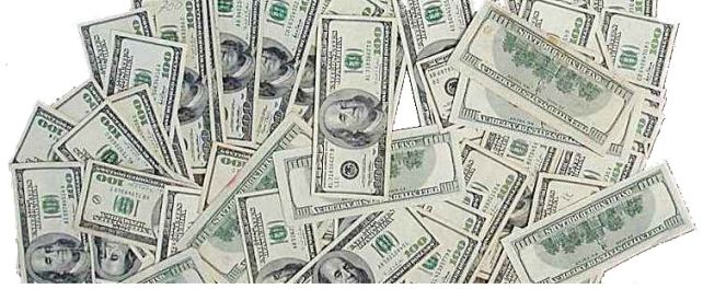 Plenty of US one hundred dollar bills (Franklins) cash spread out on a surface
